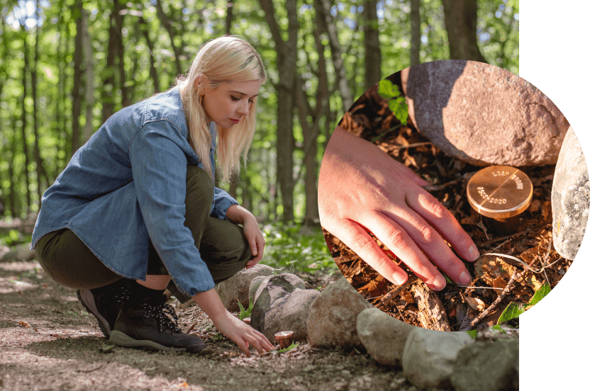 Spreading Grove St Croix Valley 21 Young woman kneeling at the edge of the stone lined trail to the Spreading Grove in Better Place Forests viewing a Memorial Marker