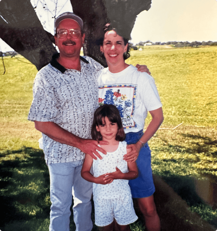 a father mother and daughter standing togather